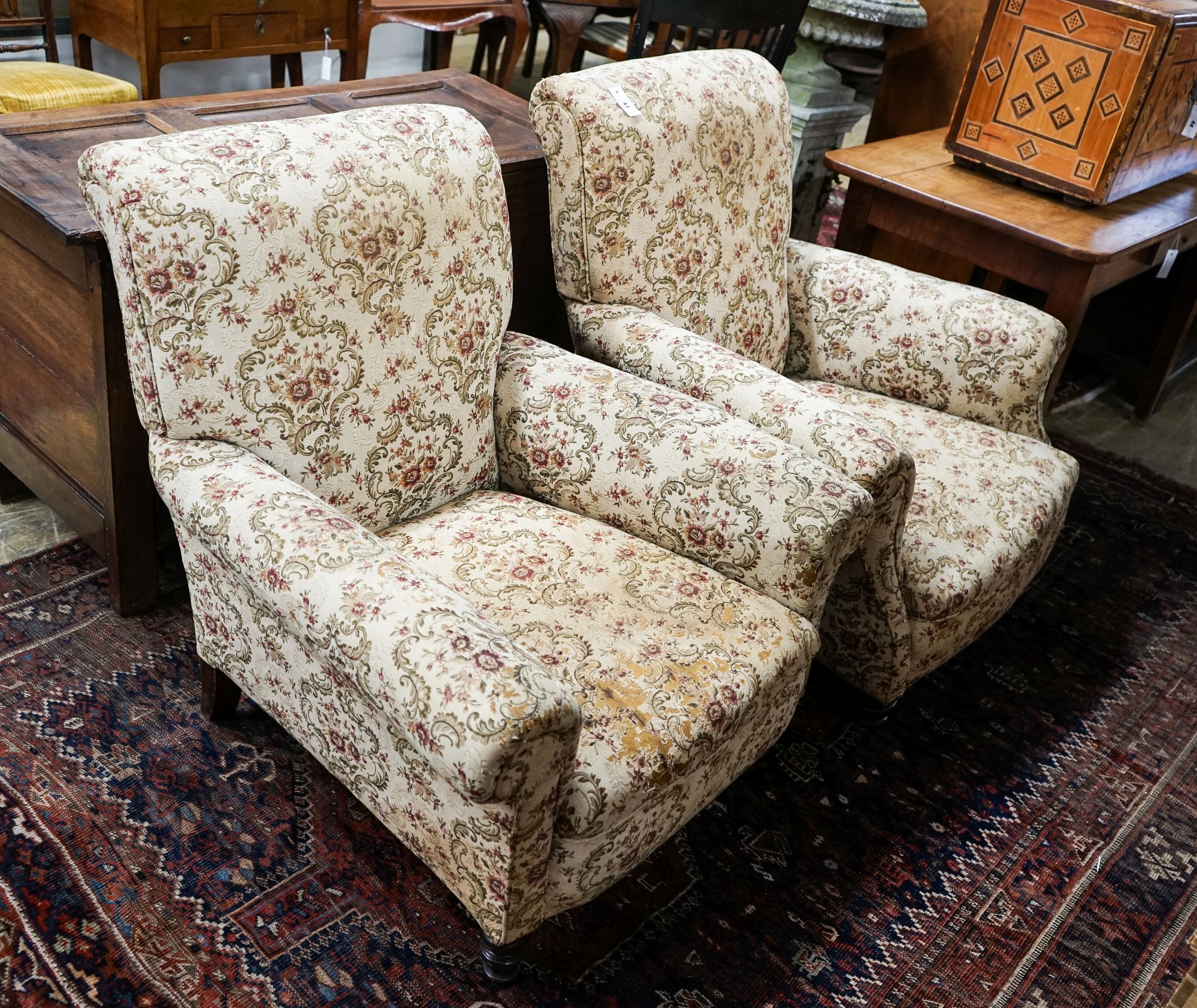 A near pair of late Victorian upholstered armchairs, width 88cm, depth 86cm, height 96cm